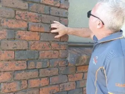 Building inspector checking the bricks
